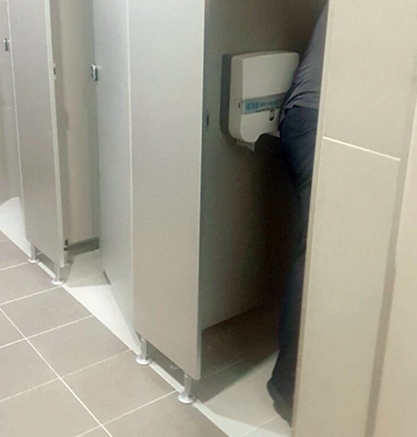 고장 난 변기를 점검하고 있는 점검원.