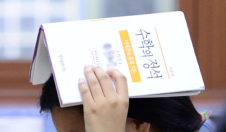 한 여고생이 수학의 정석 책을 들고 있다. / 뉴스1