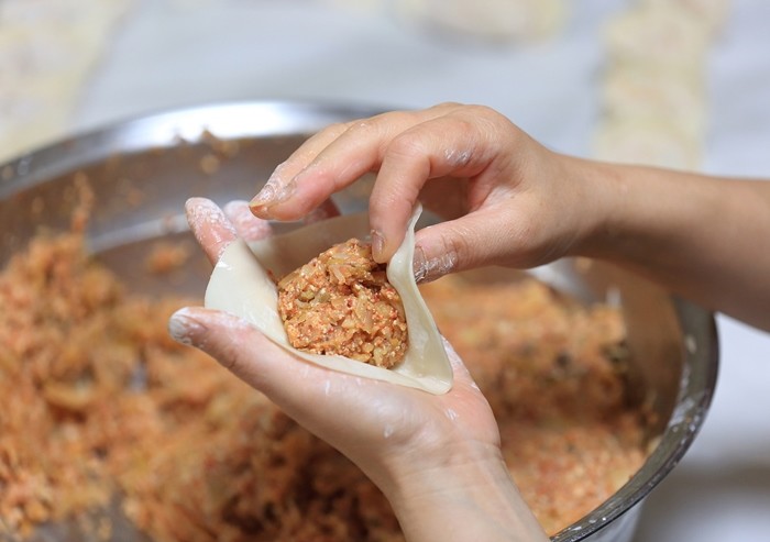 만두를 빚고 있는 여성 / Stock for you-shutterstock.com