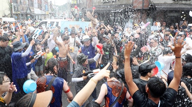 살수대첩 거리퍼레이드에 참석한 관광객들이 물을 뿌리면서 더위를 식히고 있다. / 노해섭 기자