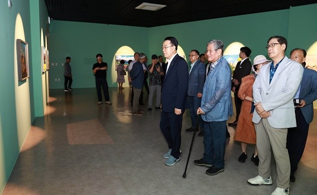 구복규 화순군수가 정완기 초대작가로부터 작품 설명을 들으며, 작품을 관람하고 있다.