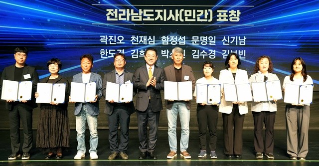 김영록 전라남도지사가 24일 무안 남도소리울림터에서 열린 ‘제26회 사회복지의 날 기념식’에 참석해 유공자에게 표창장을 수여한 뒤 기념촬영을 하고 있다.