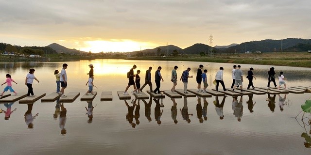 축제장 1주차장에서 주무대로 향하는 양방향 징검다리를 시민과 관광객들이 통행하고 있다.