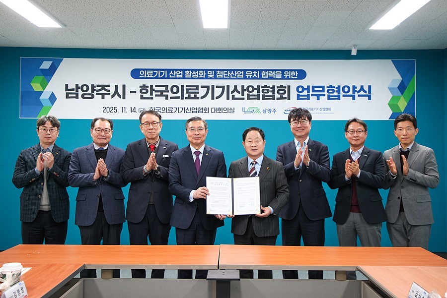 양 측 관계자가 협약서와 함께 단체사진을 촬영하고 있다