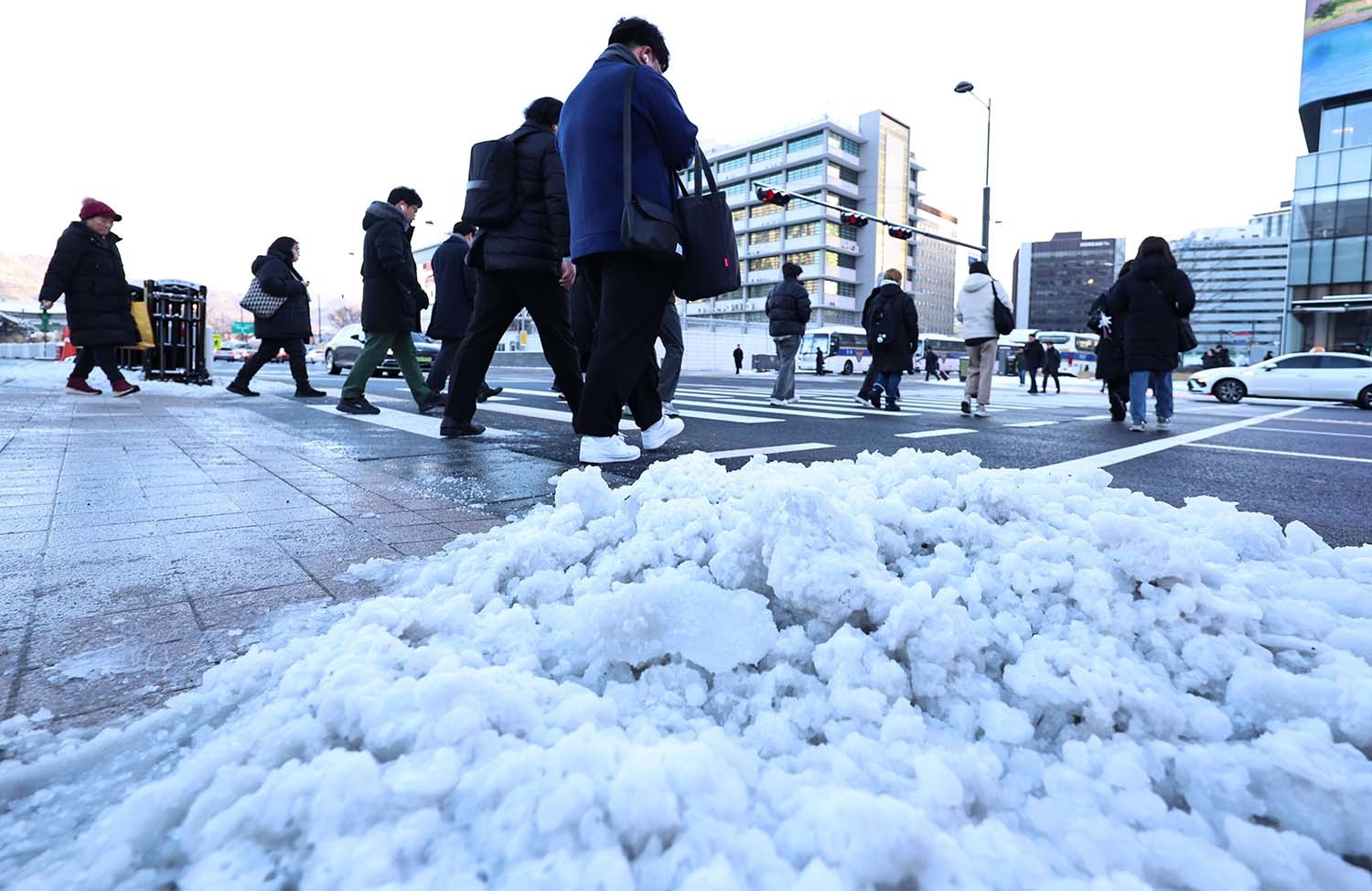 폭설 후 한파로 도로 곳곳이 얼어붙은 5일 오전 서울 광화문역 일대에서 시민들이 출근길 발걸음을 옮기고 있다. / 뉴스1