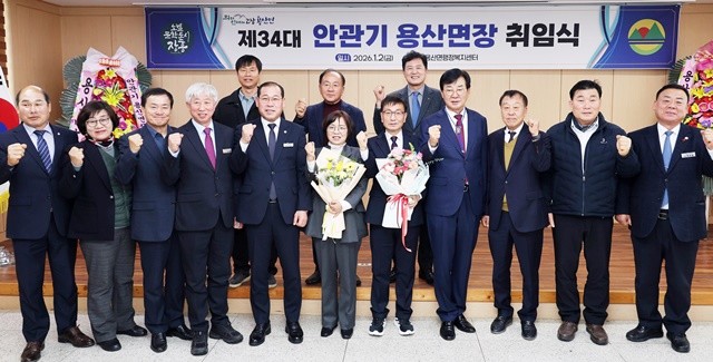 2일 열린 용산면장 취임식에서 김성 장흥군수가 안관기 신임 면장에게 ‘현장 행정’을 당부하며 운동화를 선물하고 기념촬영을 하고 있다.