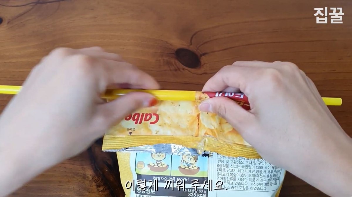 빨대를 꽂아 넣은 과자봉지 위에 반으로 가른 빨대를 감싸듯 끼우는 모습. / 유튜브 '집구석구석꿀팁, 집꿀'