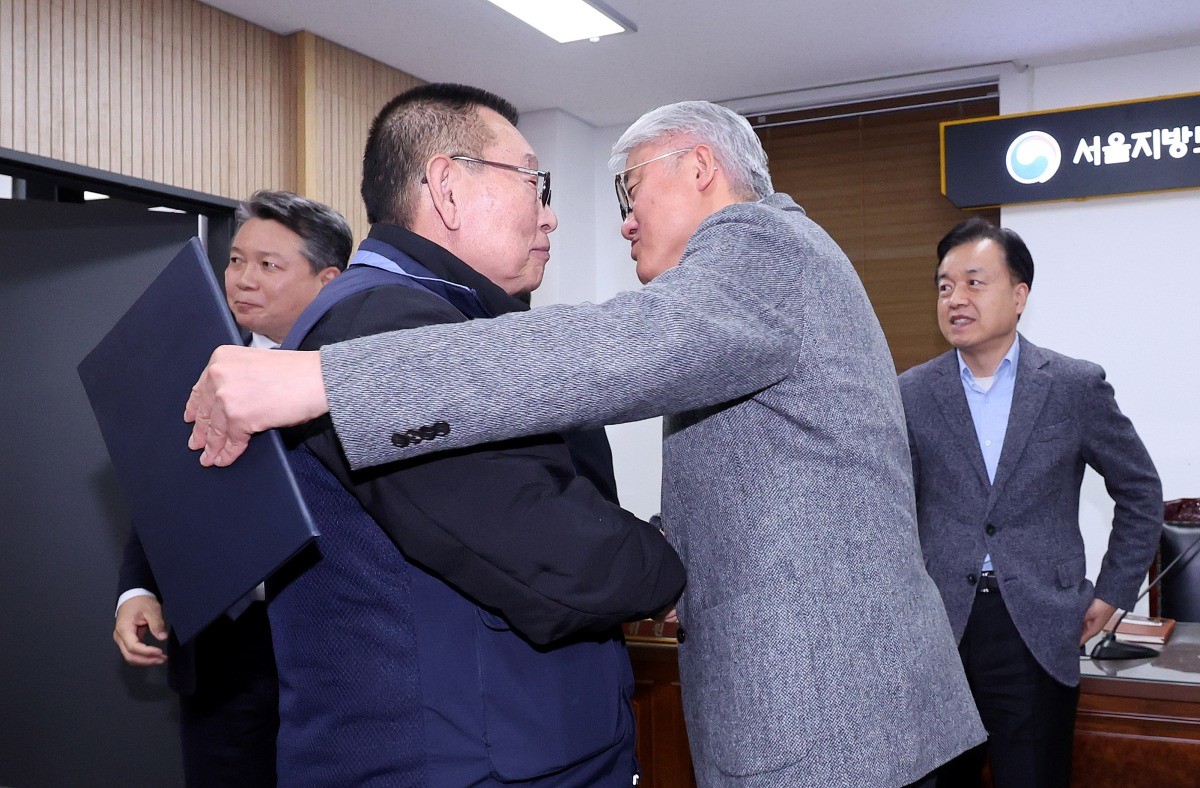 14일 서울 영등포구 서울지방노동위원회에서 열린 특별조정위원회 2차 사후 조정회의에서 서울 시내버스 노사가 임금협상에 극적으로 합의한 뒤 박점곤 서울시버스노동조합 위원장과 김정환 서울시버스사업조합 이사장이 포옹을 하고 있다. / 뉴스1