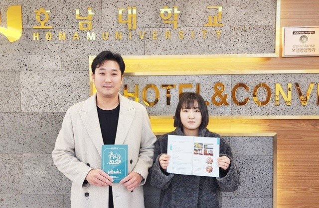 호남대 호텔컨벤션학과 이승환 교수(왼쪽)와 4학년 최가연 학생이 호슐랭 가이드 책자를 들고 기념촬영을 하고 있다.