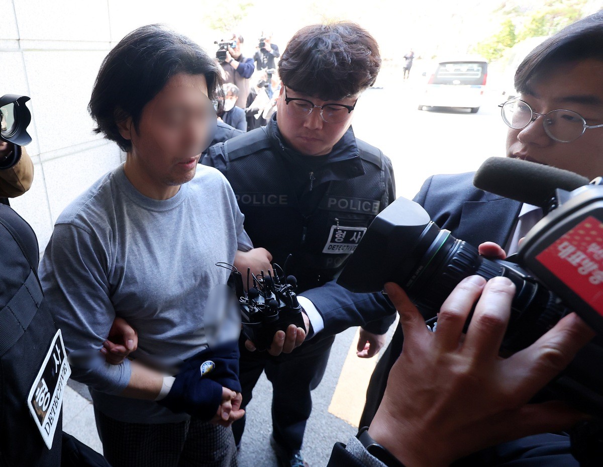 항공사 동료 기장을 흉기로 살해한 혐의를 받는 50대 전직 부기장 A 씨가 지난 20일 오후 부산 연제구 부산지방법원에서 열린 구속 전 피의자 심문(영장실질심사)에 출석하고 있다.  / 뉴스1