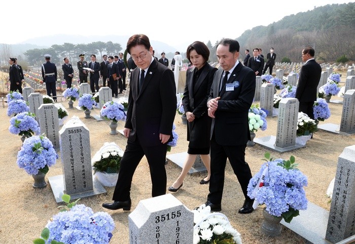 이재명 대통령과 김혜경 여사가 27일 대전 국립대전현충원 천안함 용사 묘역을 최원일 전 천안함 함장과 돌아보고 있다. / 뉴스