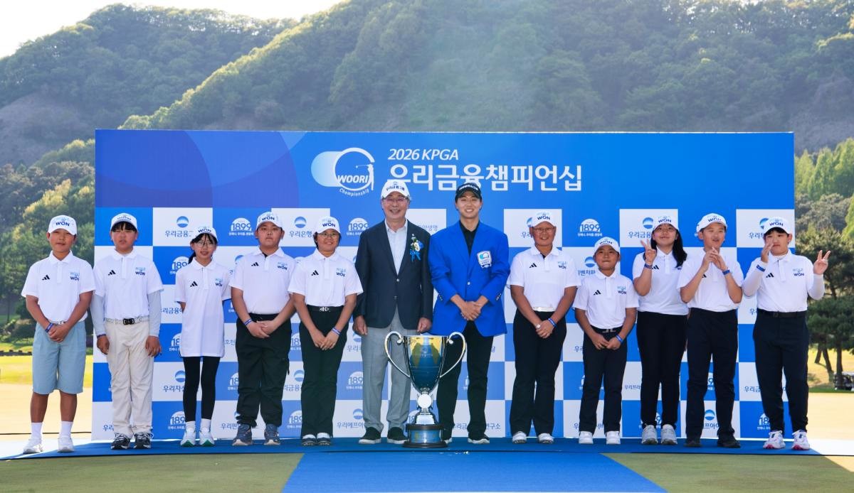 '2026 우리금융 챔피언십'에서 임종룡 우리금융그룹 회장(가운데, 왼쪽)과 우승자 최찬 프로(가운데, 오른쪽)가 골프 유망주 육성 프로그램인 ‘우리금융 드림라운드’ 참가 학생들과 기념촬영을 하고 있다. / 우리은행