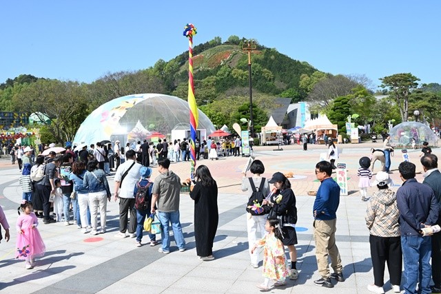 함평나비축제장 마련된 나비먹이 주기 체험장에 들어가기위해 길게 줄을 서서 대기하고 있는 관광객들 / 노해섭 기자
