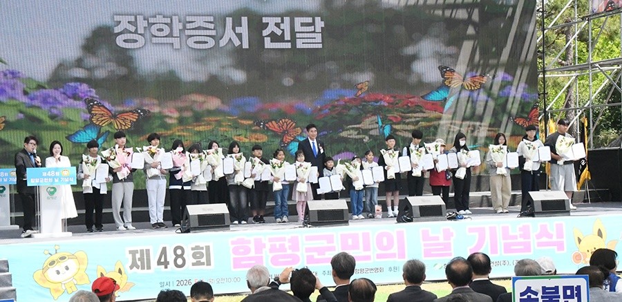 함평군은 4일 엑스포공원 나비대축제 주무대(잔디광장)에서 ‘제48회 함평군민의 날 기념식’을 개최했다.  오민수 함평군번영회장이 학생들에게 장학금을 전달하고 기념촬영을 하고 있다. / 노해섭 기자