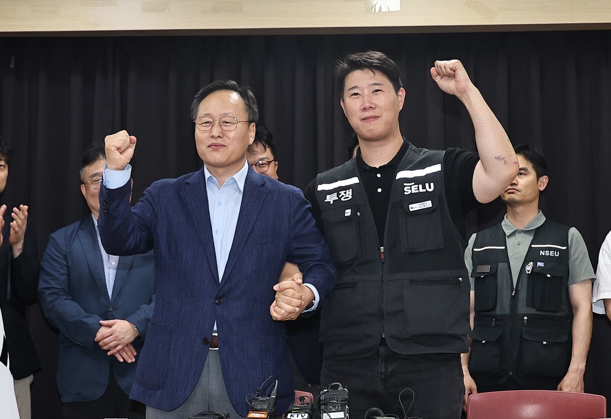 지난 20일 여명구 삼성전자 DS(디바이스솔루션·반도체 사업 담당) 피플팀장과 최승호 삼성그룹 초기업노동조합 삼성전자지부 위원장이 삼성전자 노사 잠정 합의안에 서명한 후 파이팅을 외치고 있는 모습 / 뉴스1