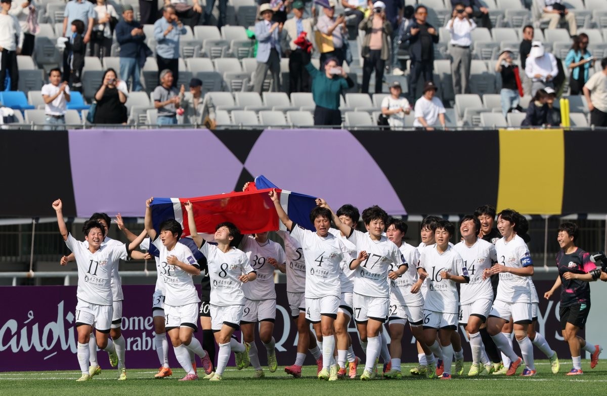 23일 오후 경기 수원시 수원종합운동장에서 열린 2025-2026 아시아축구연맹(AFC) 여자 챔피언스리그(AWCL) 결승 북한 내고향여자축구단과 도쿄 베르디의 경기에서 우승을 거둔 내고향 선수들이 인공기를 든 채 그라운드를 돌고 있는 모습. / 뉴스1