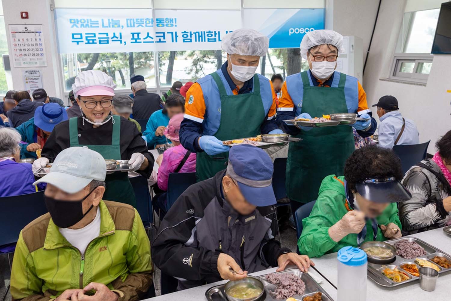 이희근 포스코 사장(가운데)과 '급식대가 이미영 셰프, 오창석 포항제철소 제강부 명장이 포항 송도동 송림노인복지관에서 특별 배식 봉사를 하고 있다. / 포스코 제공