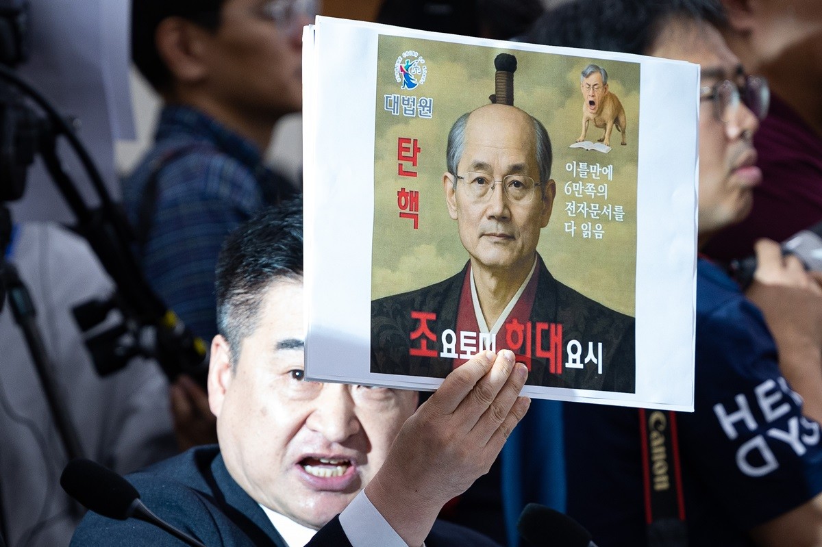 최혁진 무소속 의원이 지난해 10월 서울 여의도 국회에서 열린 법제사법위원회의 대법원 등에 대한 국정감사에서 조희대 대법원장에게 질의하며 '조요토미 히대요시'라고 적힌 손팻말을 들어보이고 있다. / 뉴스1