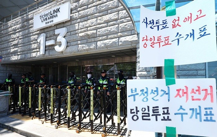 제9회 전국동시지방선거 투표용지 부족 사태를 규탄하는 개표소 봉쇄 시위가 이어지는 23일 서울 송파구 올림픽공원 핸드볼경기장 개표소 앞에 재선거를 요구하는 메시지가 붙어 있다. 2026.6.23/뉴스1