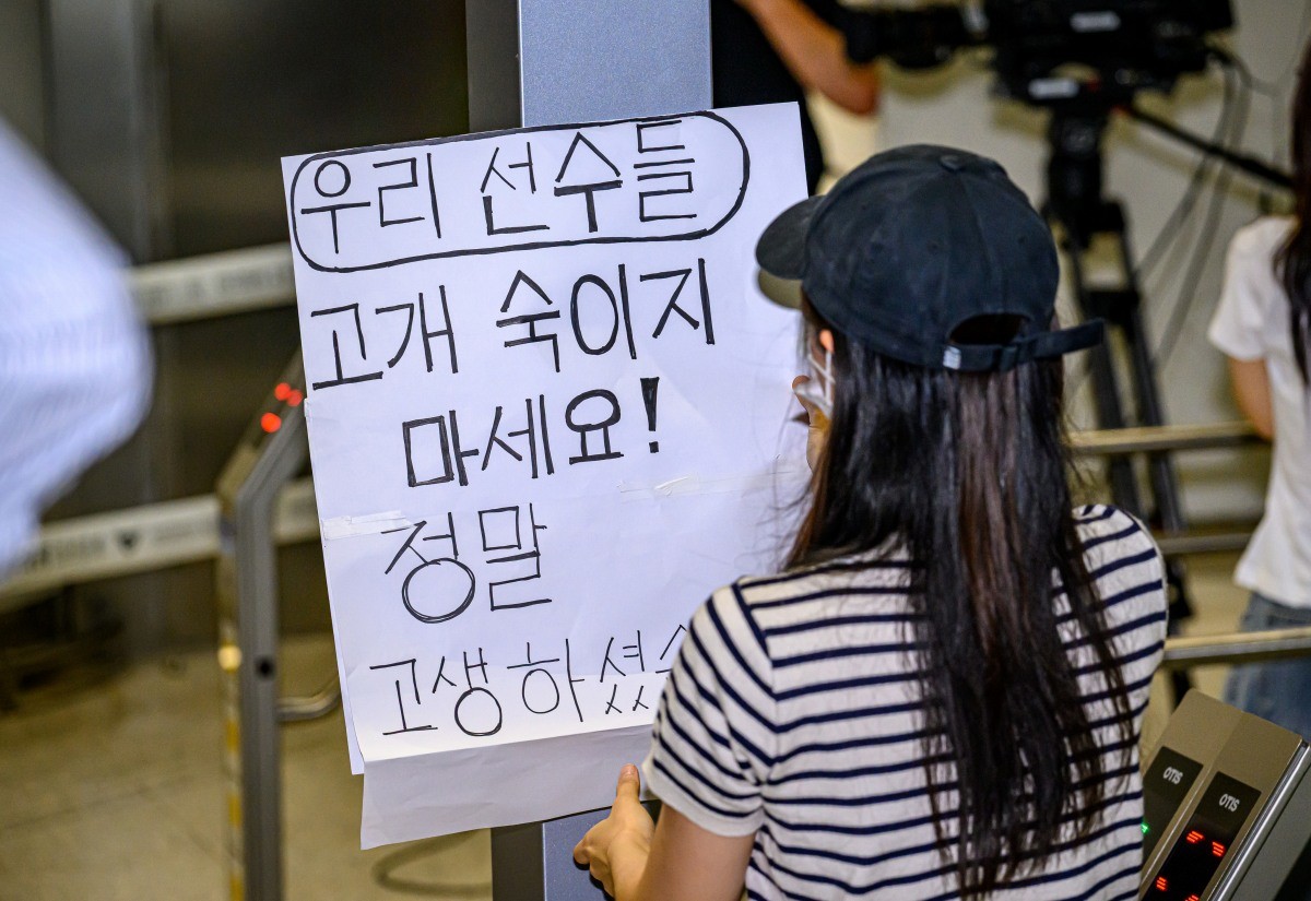 2026 북중미 월드컵을 마친 대한민국 축구대표팀이 30일 오전 인천국제공항 제2터미널에 도착한 가운데 한 여성 축구 팬이 '우리 선수들 고개 숙이지 마세요! 정말 고생하셨습니다'라는 메시지를 들고 있다 / 뉴스1