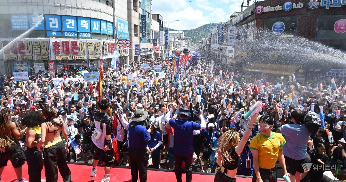 살수대첩 퍼레이드에 참석한 관광객들이 시원한 물줄기를 맞으면서 더위를 식히고 있다. / 노해섭 기자