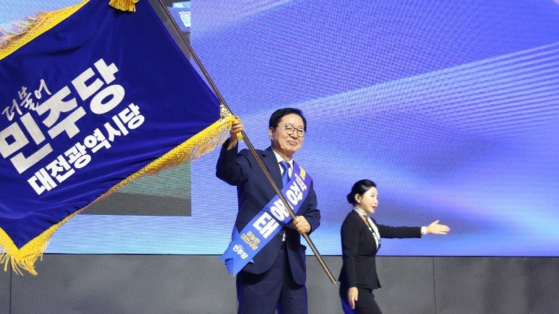 장종태 신임 더불어민주당 대전시당위원장이 1일 대전컨벤션센터(DCC)에서 열린 대전시당 당원대회에서 당선이 확정된 뒤 시당기를 흔들며 승리의 세레머니를 하고 있다.
