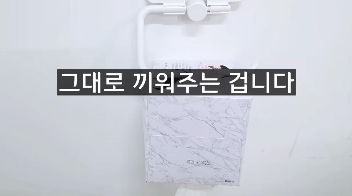 뚫어진 점선 구멍에 휴지 걸이를 건 모습. / 유튜브 '1분미만'