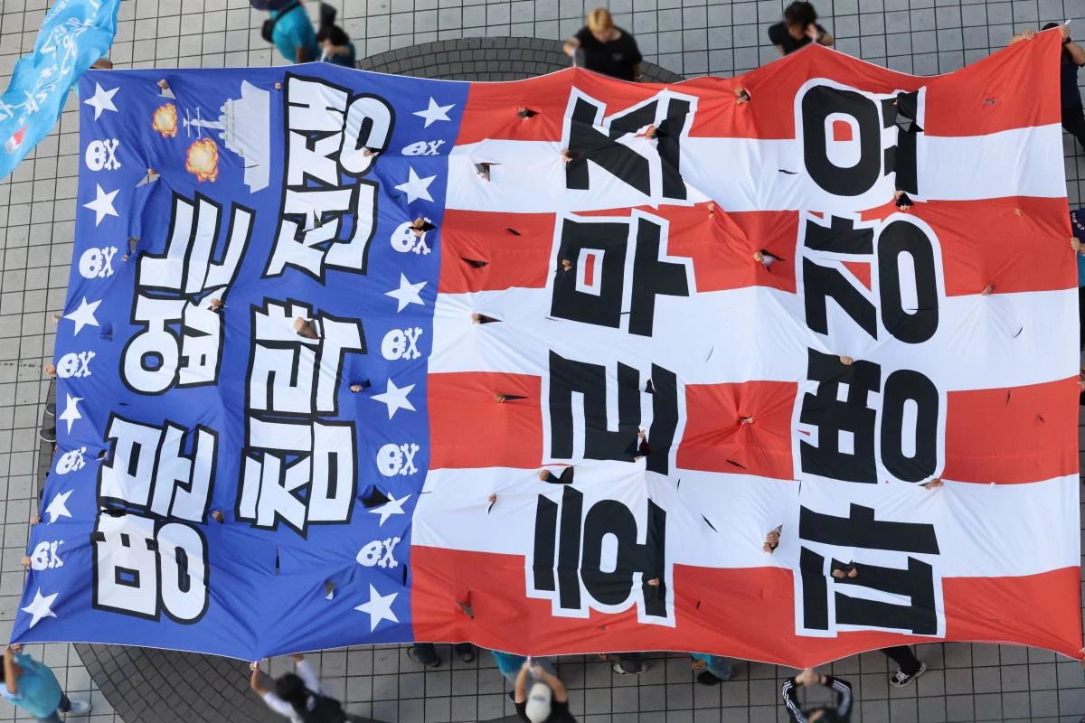 대전 중구 으능정이거리에서 열린 '호르무즈 파병 반대' 집회에서 참가자들이 '명분 없는 침략전쟁, 호르무즈 파병 강요'가 적힌 대형 현수막을 찢는 퍼포먼스를 벌이고 있다. 2026.9.12. / 연합뉴스