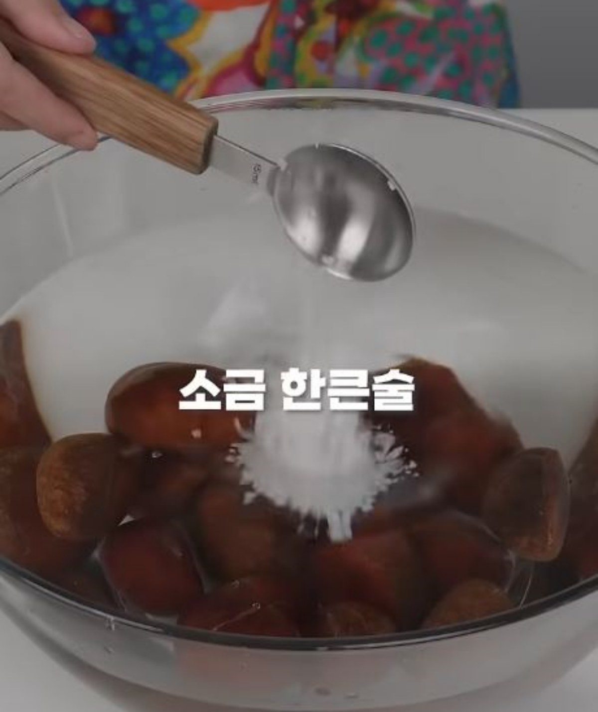 물에 담궈둔 밤에 소금 한 큰술을 넣는 모습. / 유튜브 '어썸식탁 | 어썸테이블'