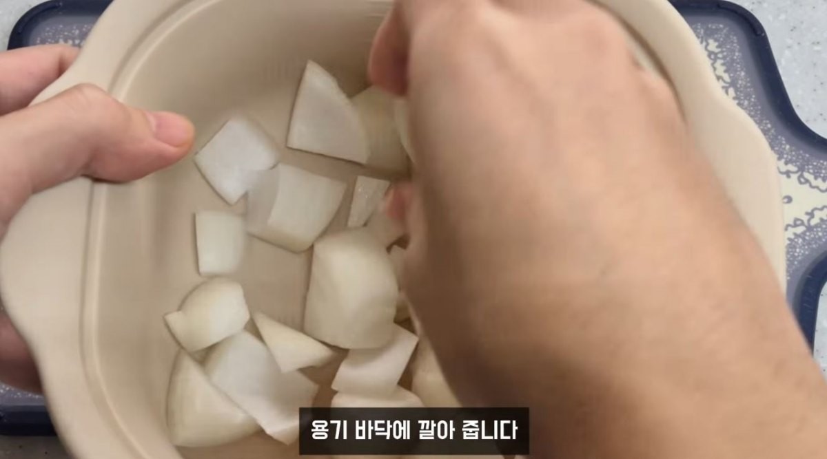 양파 반 개를 전자레인지용 용기 아래에 깔아주는 모습. / 유튜브 '야미양yummy | 간단한끼'