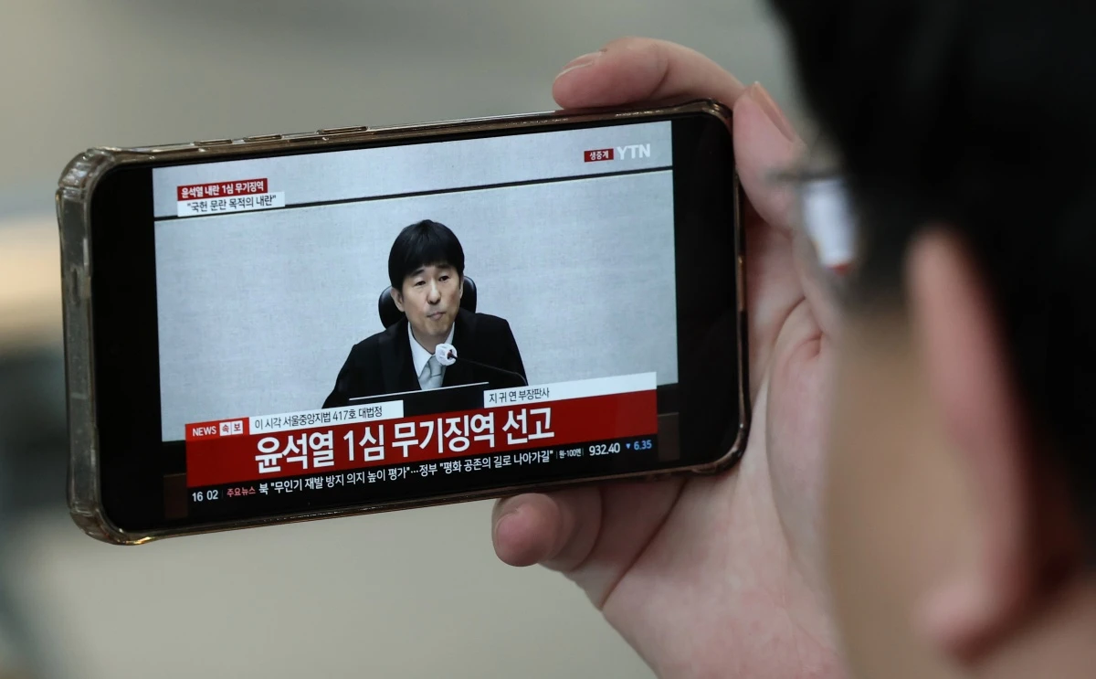 지난 2월 19일 대전역 대합실에서 시민들이 윤석열 전 대통령의 내란 우두머리 혐의 1심 선고 생중계를 시청하고 있다. 당시 윤 전 대통령은 1심에서 무기징역을 선고받았다. / 뉴스1